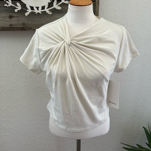 lululemon athletica Tops - Lululemon Asymetrical front twist cream t-shirt Top cropped length XL‎ NWT